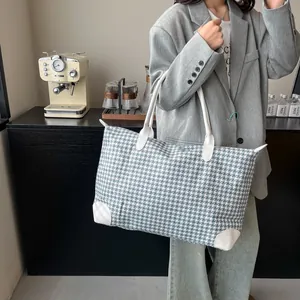 Large blue and white houndstooth travel bag with white leather straps for travel or fitness