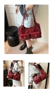 Detail view of burgundy PU leather handbag featuring multiple pockets and silver buckles