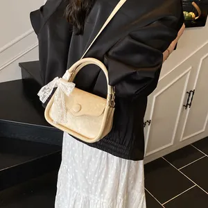 Chic cream-colored small crossbody bag with lychee texture and lace ribbon bow detail