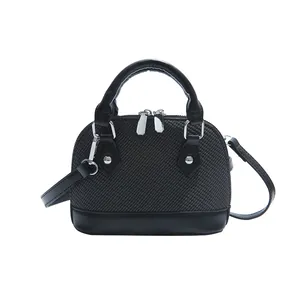 Classic black shell-shaped handbag with textured weave and adjustable shoulder strap