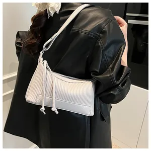 Detail of off-white pleated shoulder bag in high-quality textured leather with side drawstrings