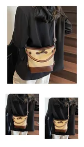 Dettagli della borsa a secchiello in tela vintage con finiture in pelle marrone