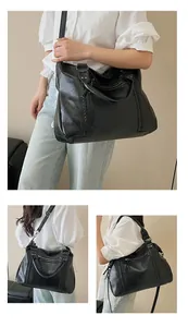 Detail view of large black faux leather tote bag with woven patterns and zipper pockets