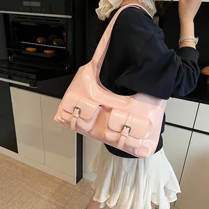 Pink glossy patent leather shoulder bag with double pockets and chic crescent design