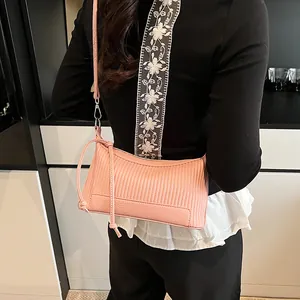 Pink vintage hobo underarm bag with vertical stripe embossing and lychee texture