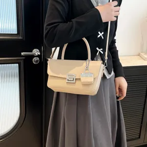 Fashionable beige crossbody bag with woven leather texture and mini pendant charm