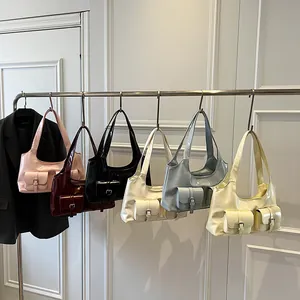Retro multi-pocket faux leather shoulder bags in assorted colors hanging on a rack