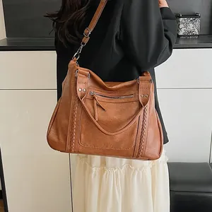 Retro brown large capacity tote bag worn by model with adjustable shoulder strap