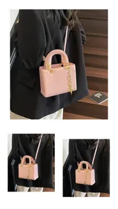 Detail of pink cartoon embossed handbag with gold hardware and star pendant