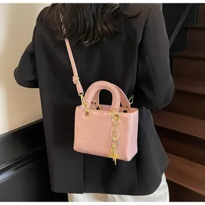 Detailed macro view of pink embossed PU leather bag with cute cartoon patterns and gold star charm