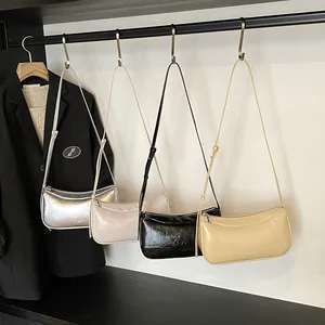 Chic underarm bags in silver, grey, black and cream shown in a minimalist display