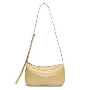 Chic beige crescent underarm bag in glossy leather with adjustable strap for women