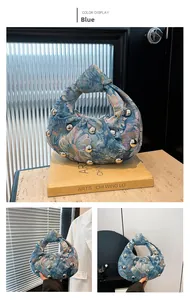 Detailed view of blue floral jacquard texture with silver round studs and knotted handle