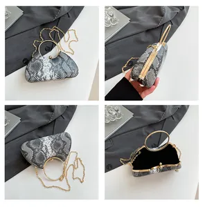 Detailed views of faux snake print evening clutch with gold ring handle and chain strap
