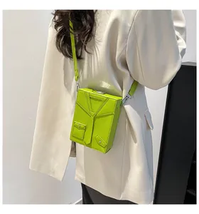 Close-up of bright grass green lychee leather crossbody bag with creative jacket design