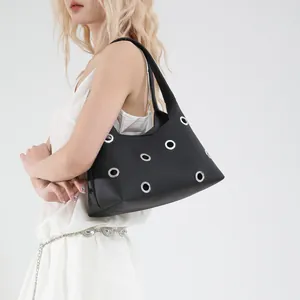 Minimalist black leather underarm bag with stylish silver metal eyelet decorations