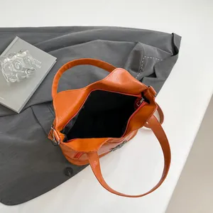 Orange lychee pattern PU leather tote bag with silver logo and top zipper closure