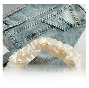 Detailed close-up of white satin ruffled handbag with smooth texture and comfortable handle