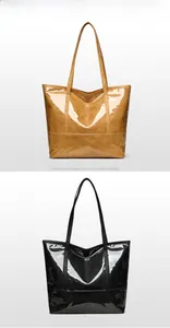 Close-up of glossy patent leather tote bags in yellow and black with long handles