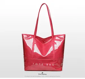 Close-up of pink glossy tote bag showing shiny texture and TOTE BAG lettering detail