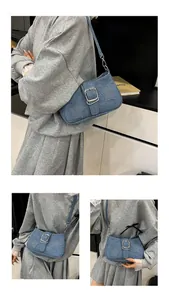 Detail view of blue denim baguette bag with rhinestone stars and silver metal buckle
