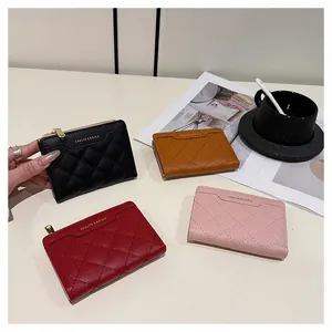Detailed view of quilted leather wallets in multiple colors with sleek metal zip closure