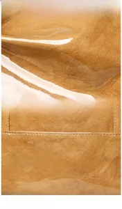 Detailed macro shot of textured tote bag with glossy finish and white printed logo