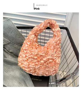 Detailed view of a pink satin handbag with ruffle layers placed in a metal shopping basket