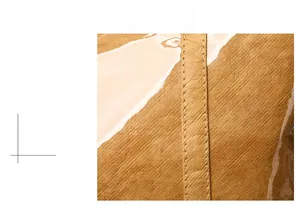 Detailed macro view showing the precise double stitching on the brown textured tote bag