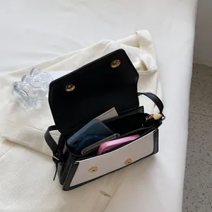 Contrast panel shoulder bag with three inner compartments and magnetic flap closure