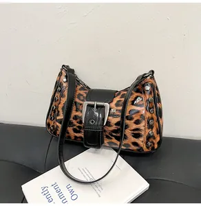 Detailed macro view of leopard print bag with silver studs and metal buckle detail