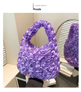 Detailed view of the purple ruffled lace handbag showing soft fabric and layered texture