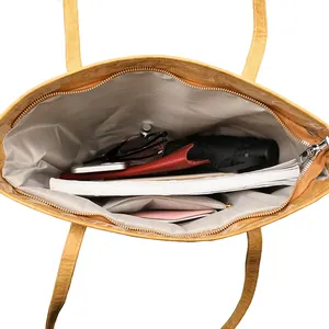 Spacious yellow leather tote bag interior with large capacity and zippered pocket