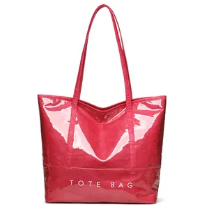 Retro fuchsia patent leather tote bag with white TOTE BAG print and slim shoulder straps
