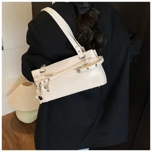 Detail of cream PU leather shoulder bag with silver buckle and star heart pendants