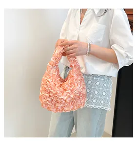 Close-up of pink ruffled handbag showing layered satin texture and sweet girlish design