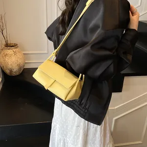 Minimalist yellow pillow bag with lychee texture and shoulder strap for casual styling