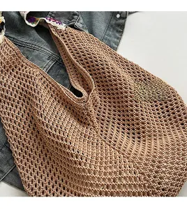 Gros plan du sac fourre-tout au crochet kaki montrant les détails de la bandoulière