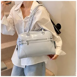 Close-up of light blue glossy patent leather Boston bag with belt buckle details