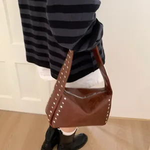 Brown vintage Y2K shoulder bag with silver rivet details and retro street style design