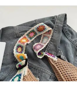 Détail de la bandoulière fleurie au crochet et de la texture du sac tissé beige