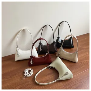 Detailed close-up of six crescent PU leather shoulder bags in various colors with silver chains