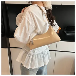 Close-up of cream PU shoulder bag featuring glossy finish and designer silver zipper pull
