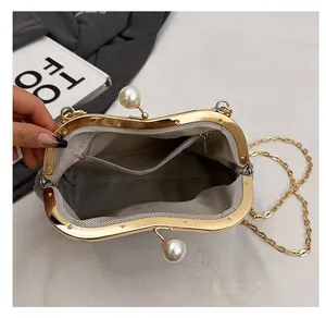 Detail of beaded bag with gold frame, large pearl clasp, and grey herringbone lining