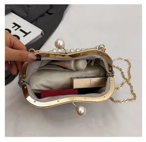 Detail showing inner storage and pearl clasp of a vintage ethnic style beaded chain bag