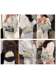 Ethnic style embroidered handbag featuring pearl handle and detachable chain strap