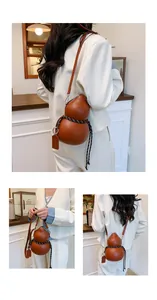 Detailed macro view of brown gourd-shaped crossbody bag with braided rope and leather tag