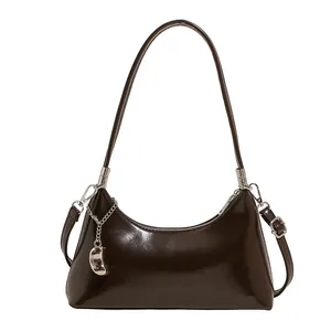 Dark brown high-gloss patent leather shoulder bag with metallic chain and bean charm