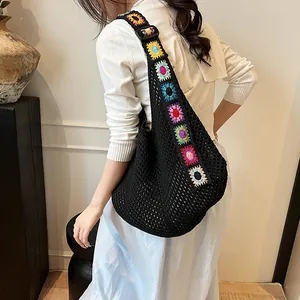 Grand sac hobo noir en maille avec bandoulière au crochet colorée porté par un mannequin