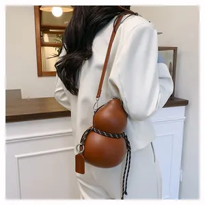 Close-up of brown gourd-shaped leather crossbody bag with decorative braided rope detail